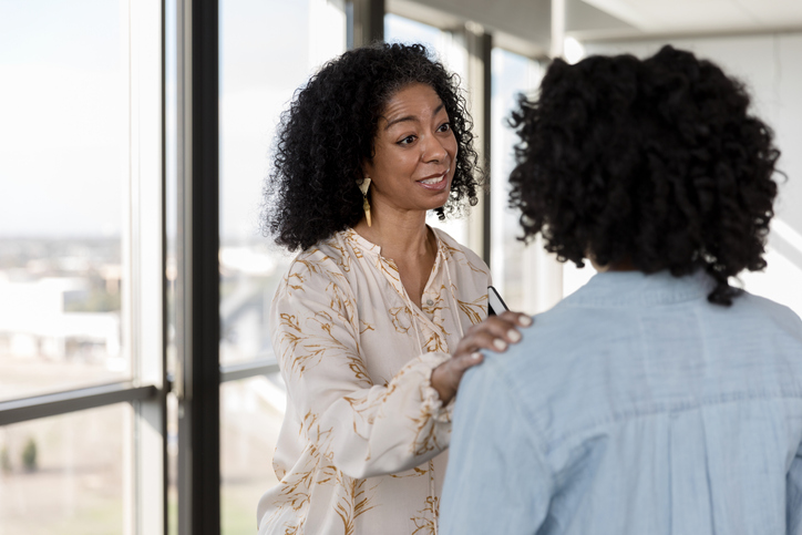 black woman hugging a friend