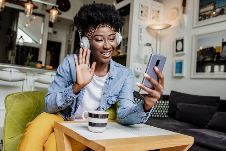 A young African-American woman communicates via video call