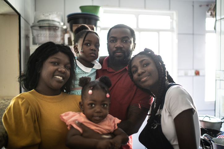 Portrait of a family together at home