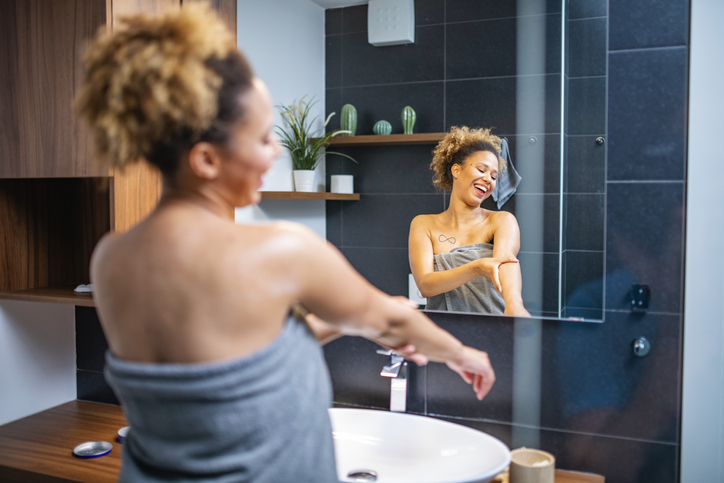 Beautiful Mixed Race African Woman Doing her routine in bathroom