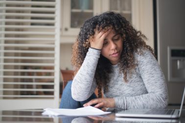 Woman of African Descent Frustrated While Doing Taxes