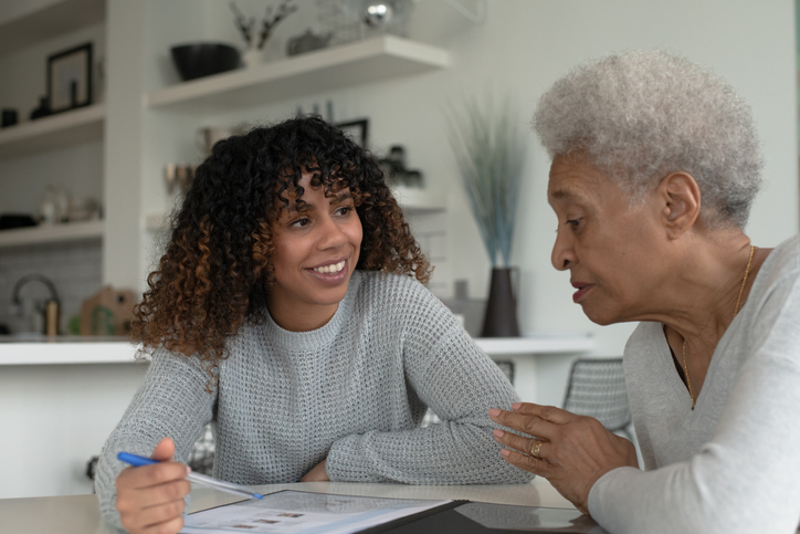 An African American Adviser Meets with A Senior Client stock photo