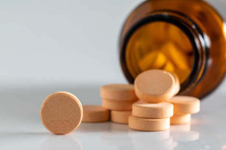 Yellow vitamin pills isolated on a white background