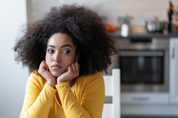 Depressed afro woman at home