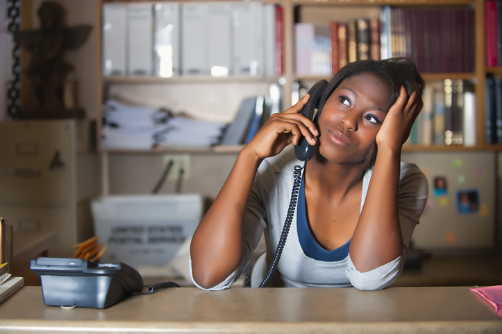 USA, Texas, Young woman having conversation in office