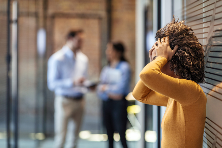 Female African American office worker reacts negatively to bad news