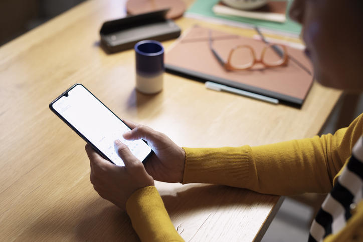 Hands of an Anonymous Businesswoman Writing Messages on her Mobile Phone, a Close Up