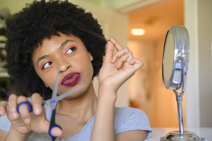 Young woman contemplating cutting her hair