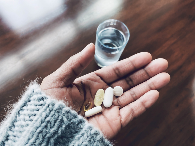 Woman Holds Nutritional Supplements
