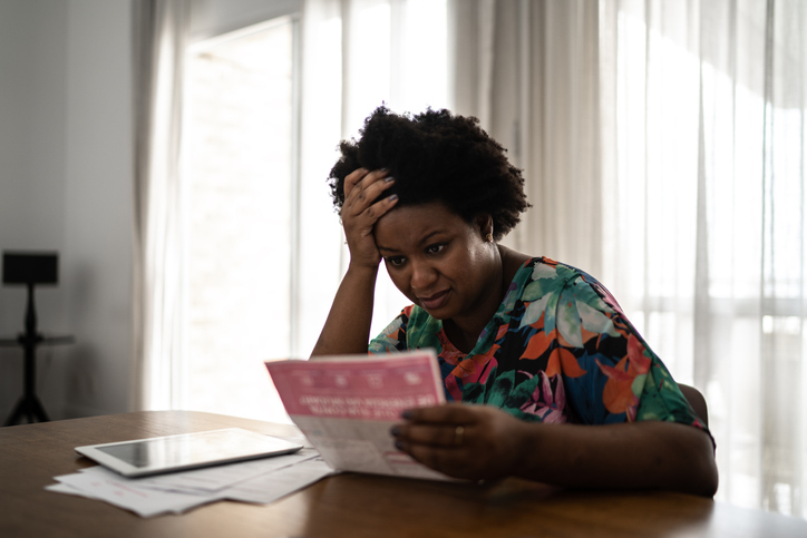 Worried woman looking for financial bills at home