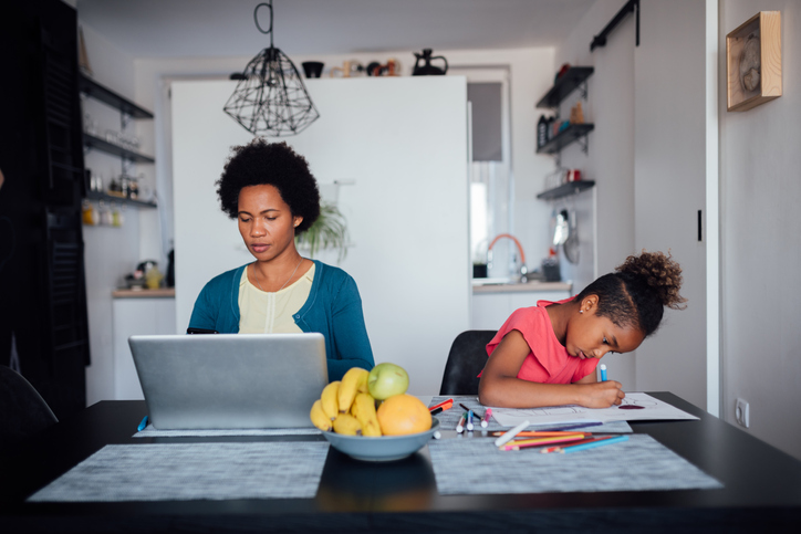 Young African American mother looking for a job using internet