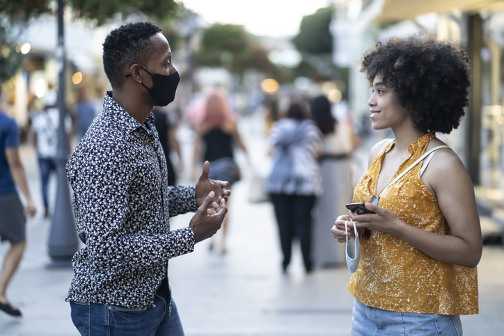 Young afro couple on a date keeping social distance