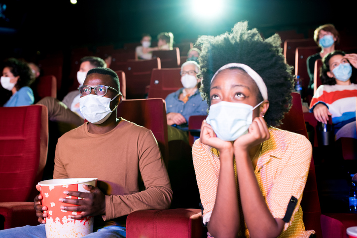 African-American couple watching a movie at the cinema during Covid-19 pandemic