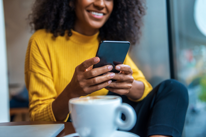 Relaxed business-elegant woman enjoys her free time in a cafe