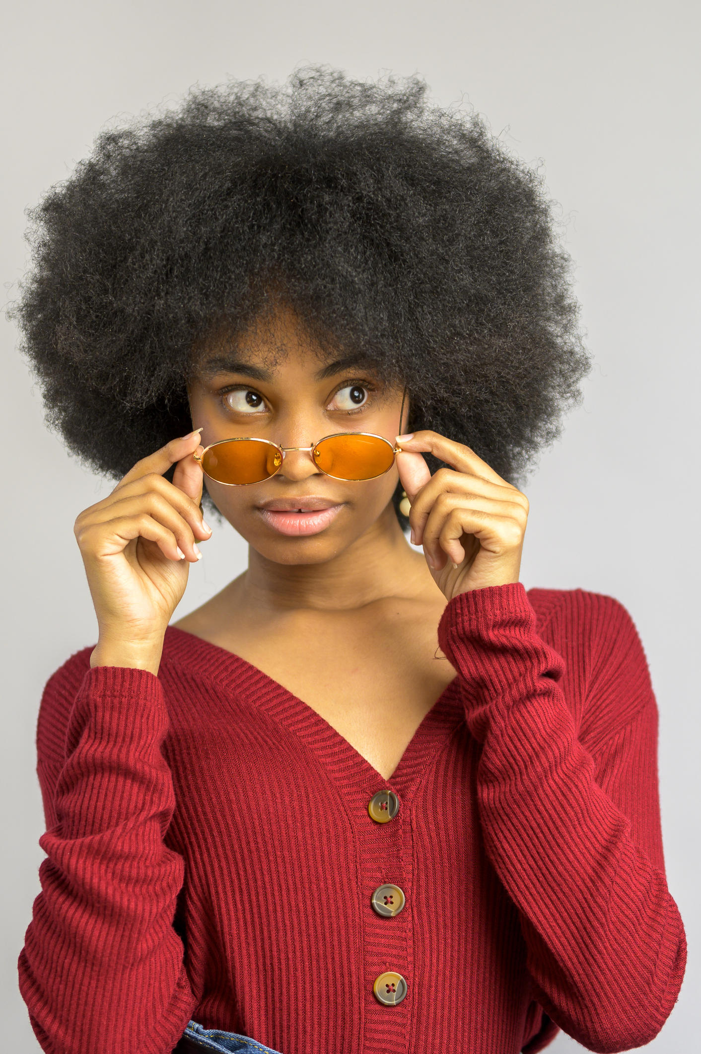 Young woman looking over her sunglasses