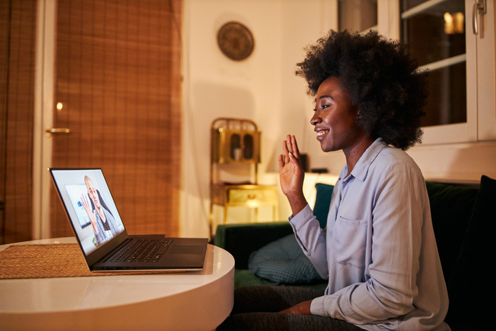 Businesswoman greeting her colleague on a video conference
