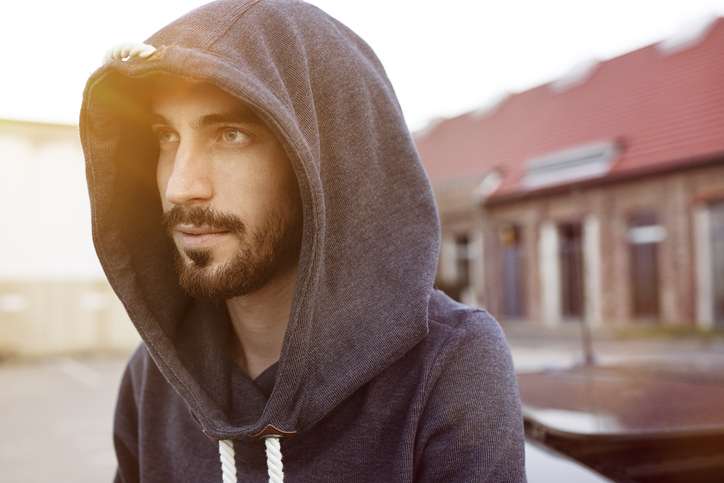 Portrait of bearded young man wearing hooded jacket
