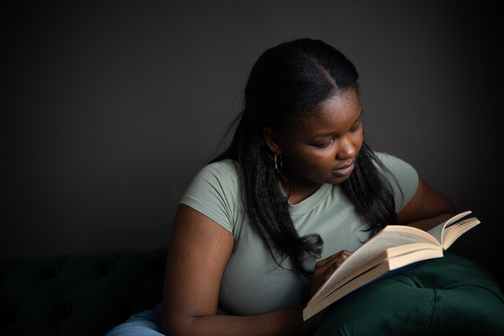 Portrait of a young woman reading a book