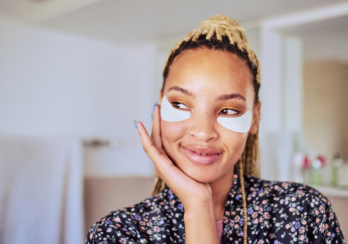 Shot of a woman wearing under-eye gel patches as part of her beauty regime