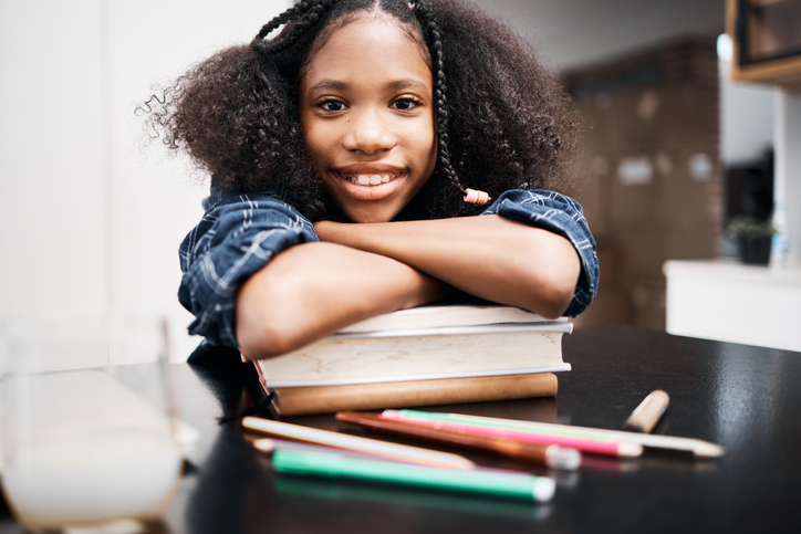 Portrait of a young girl doing a school assignment at home