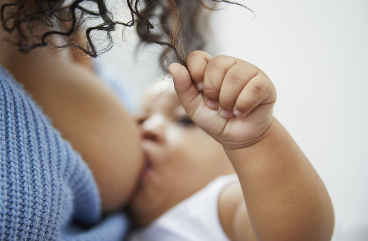 Mother breastfeeding baby boy