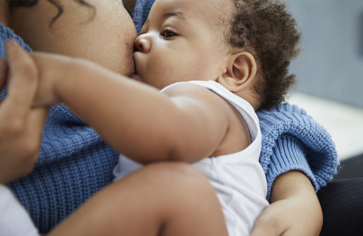 Mother breastfeeding baby boy