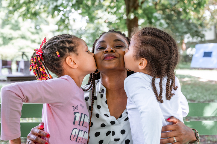 Mother with two little children outdoors