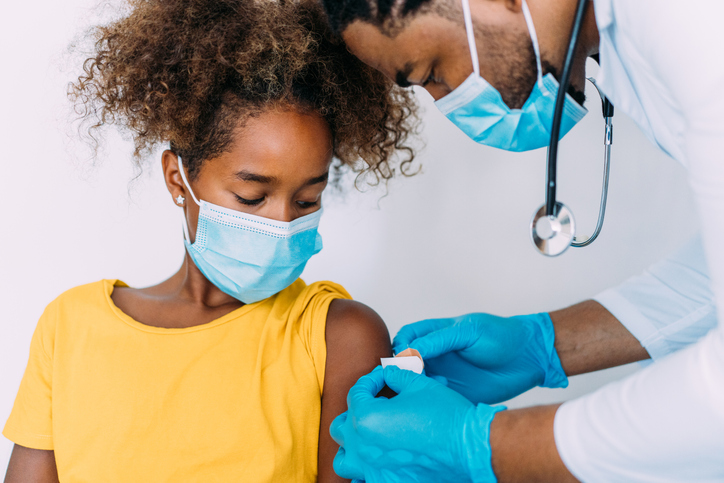 Doctor putting a bandage after Covid-19 vaccination.