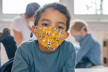 Happy masked child at daycare