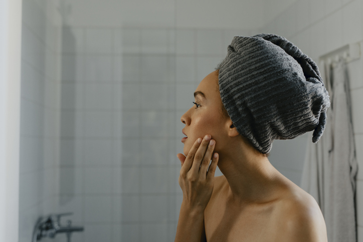 Beautiful Afro Woman Gussying up in the Bathroom