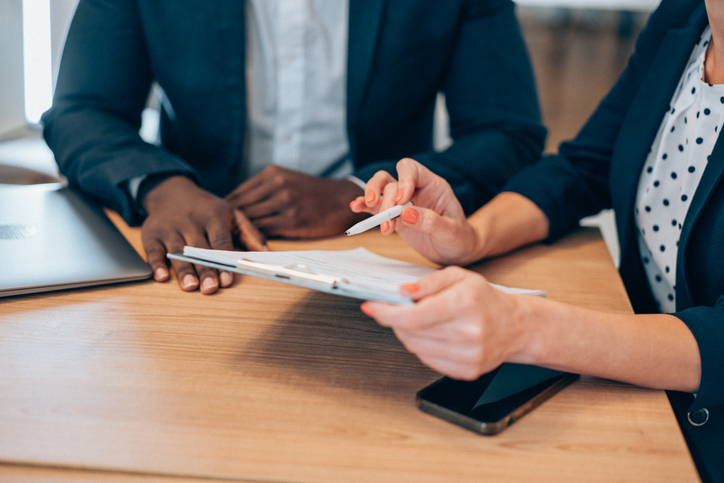 Business people signing a contract.