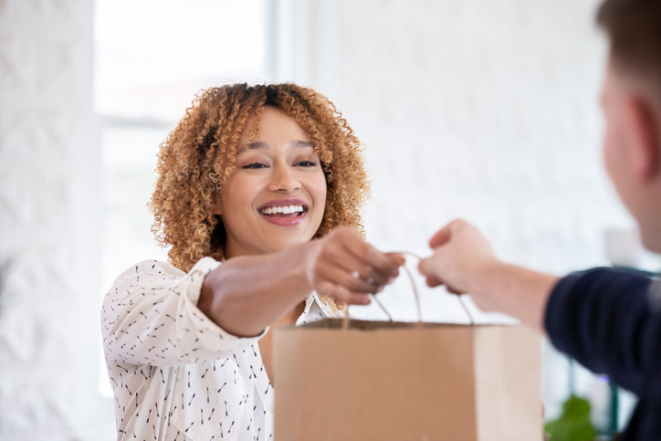 Clerk Handing Bag to Costumer