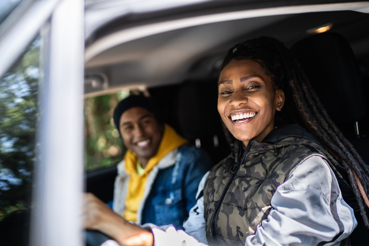 Portrait of couple or friends driving in an road trip