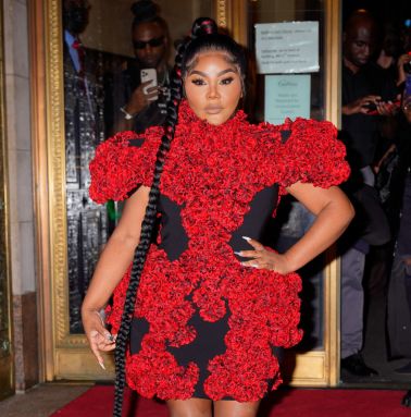 Lil Kim wears a red dress.
