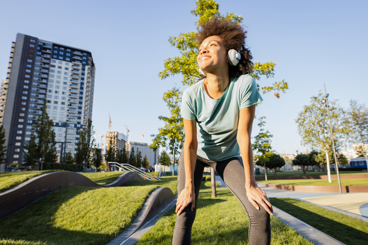 Beautiful young woman resting after working out outdoor