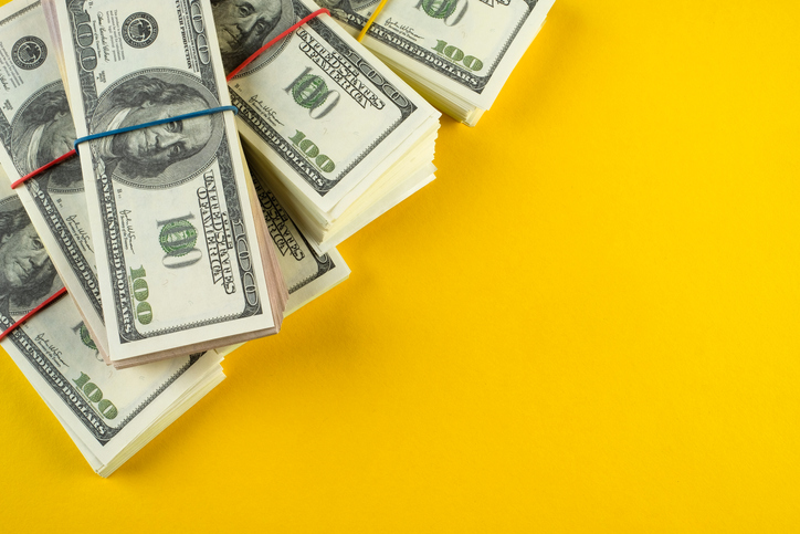 A banknote in US dollars in bundles On a bright background. The concept of finance and economics, investments. Salary, bribe, profit or credit funds. Space for copying.