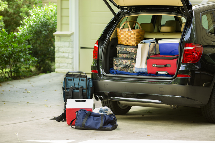 Family vehicle packed, ready for road trip, vacation outside home.
