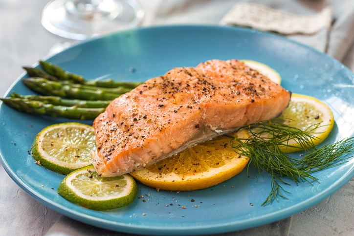 Grilled fillet of salmon with asparagus served on a plate