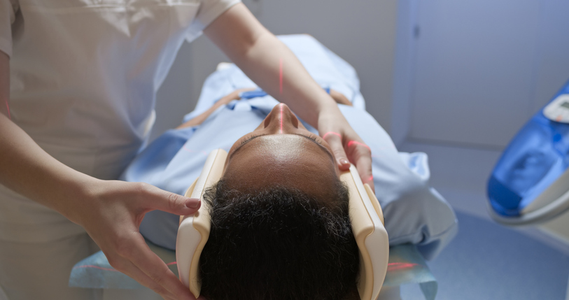Female doctor sliding her patient into the MRI scanner