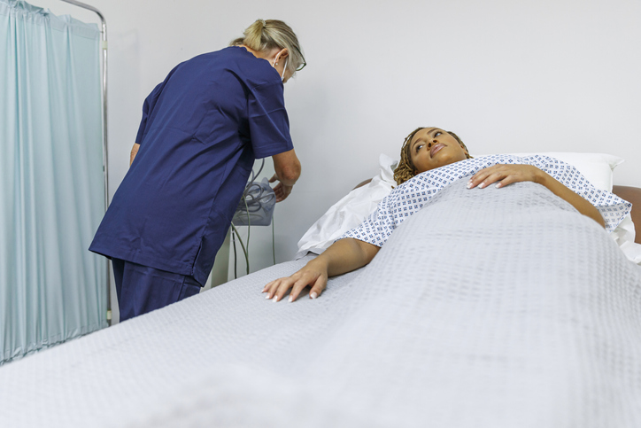 Young female patient in hospital bed