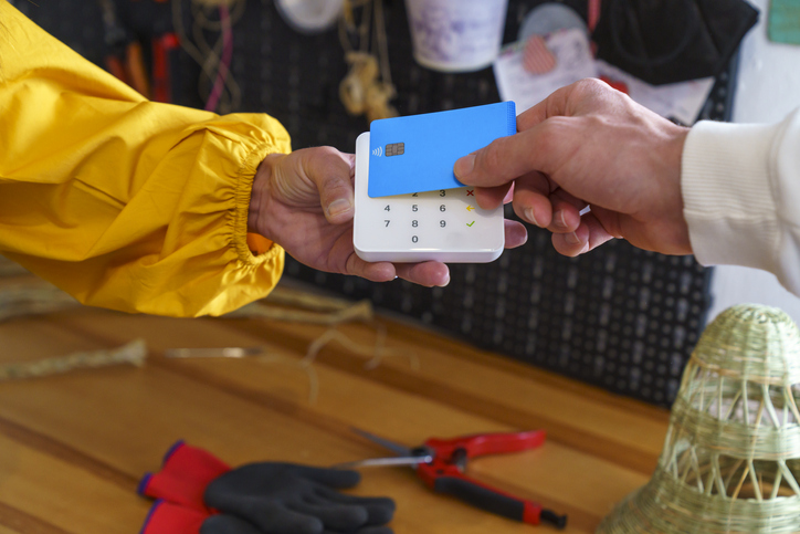 Man Making Payment With Credit Card In The Espartera Woman Workshop