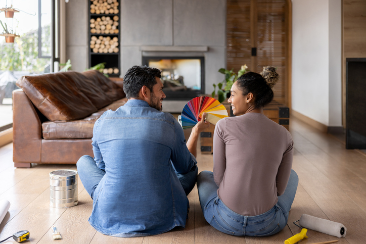 Couple painting their house and electing a color from a palette
