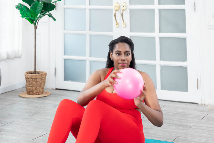 Woman exercising on a fitness ball at home