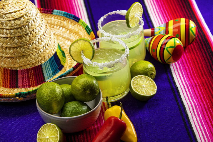 Happy Cinco de Mayo with two Margarita Glasses on a Colorful Mexican Blanket