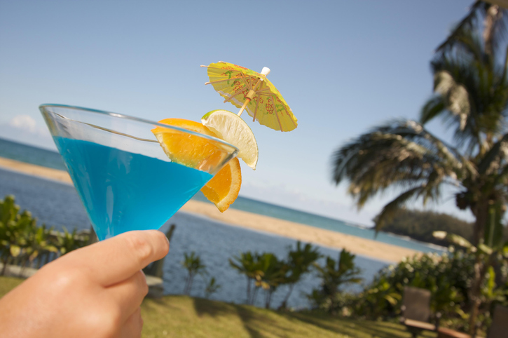 Woman with tropical drinks on Lanai, Hawaii, USA