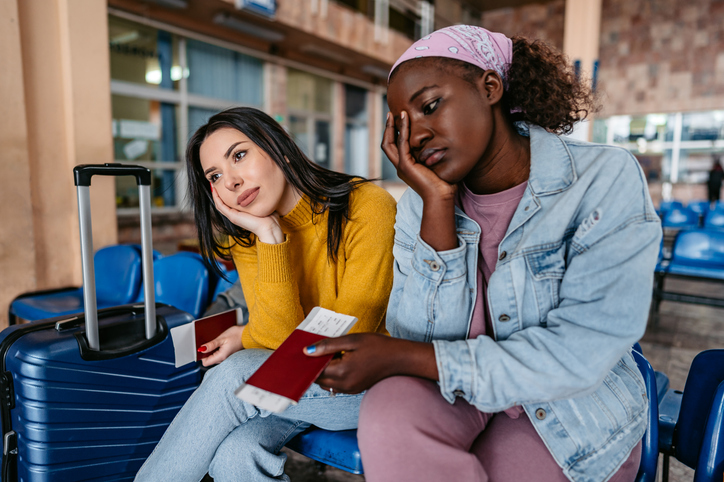 Two Young Tourists Waiting At The Station during a long layover