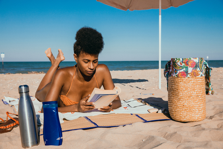 Woman enjoying feel-good books by black authors