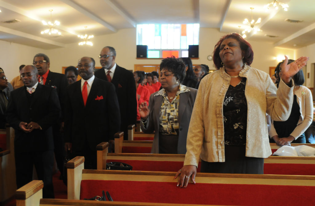 Photo by Lauren A. LittleFebruary 6, 2011St Johns Missionary Baptist ChurchDorothy Berry (in tan-ish gold jacket, hand raised) of Reading sings along with the choir as they process in during Sunday's service at St. John's Missionary Ba