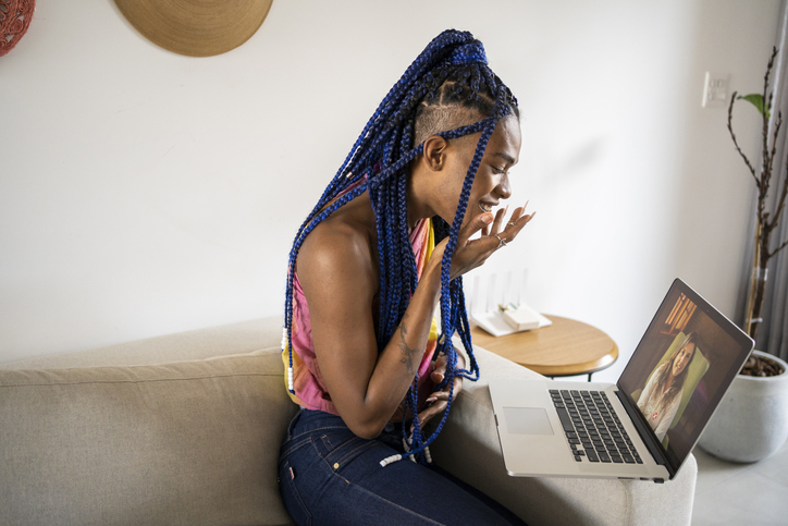 African American transgender woman in video call of online psychotherapy. Telemedicine and mental healthcare concept.