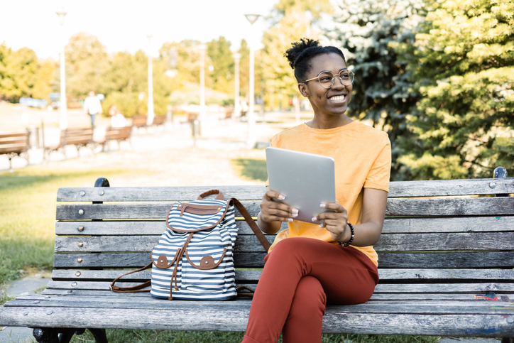 African American girl enjoying outdoors and using tablet